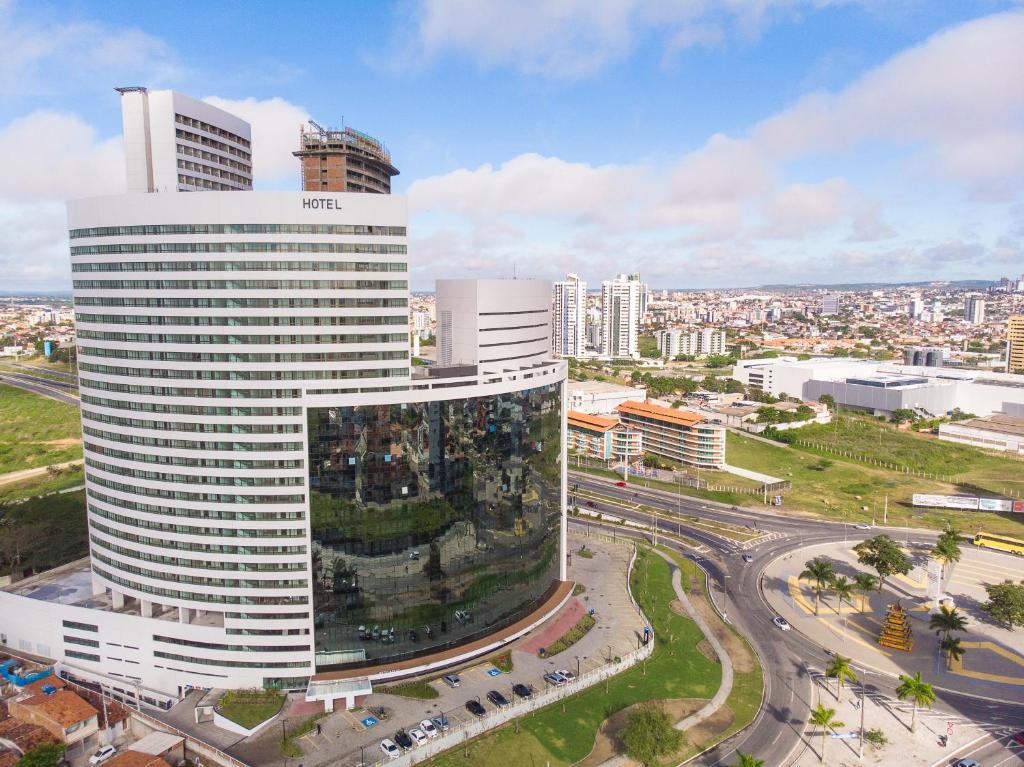 a tall white building with a city in the background at Slaviero Campina Grande in Campina Grande