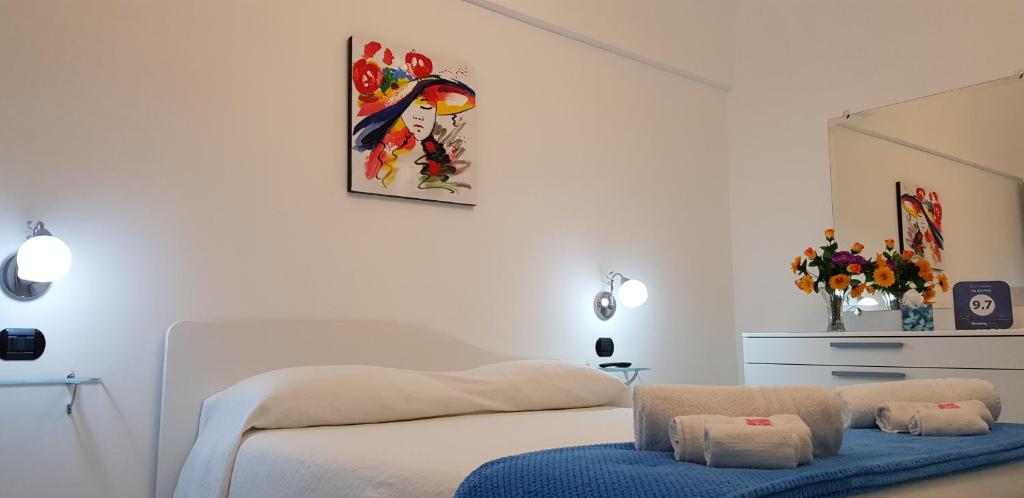 a bedroom with a white bed with a blue stool at Da Zia Pina in Minori