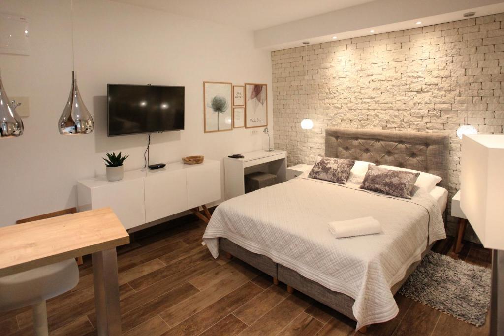 Postel nebo postele na pokoji v ubytování Apartments Tessera