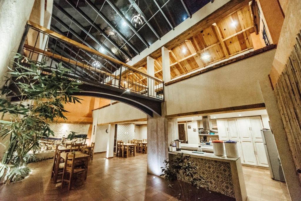 a large room with a kitchen and tables and chairs at Kotantik bed & breakfast in San Crist&oacute;bal de Las Casas