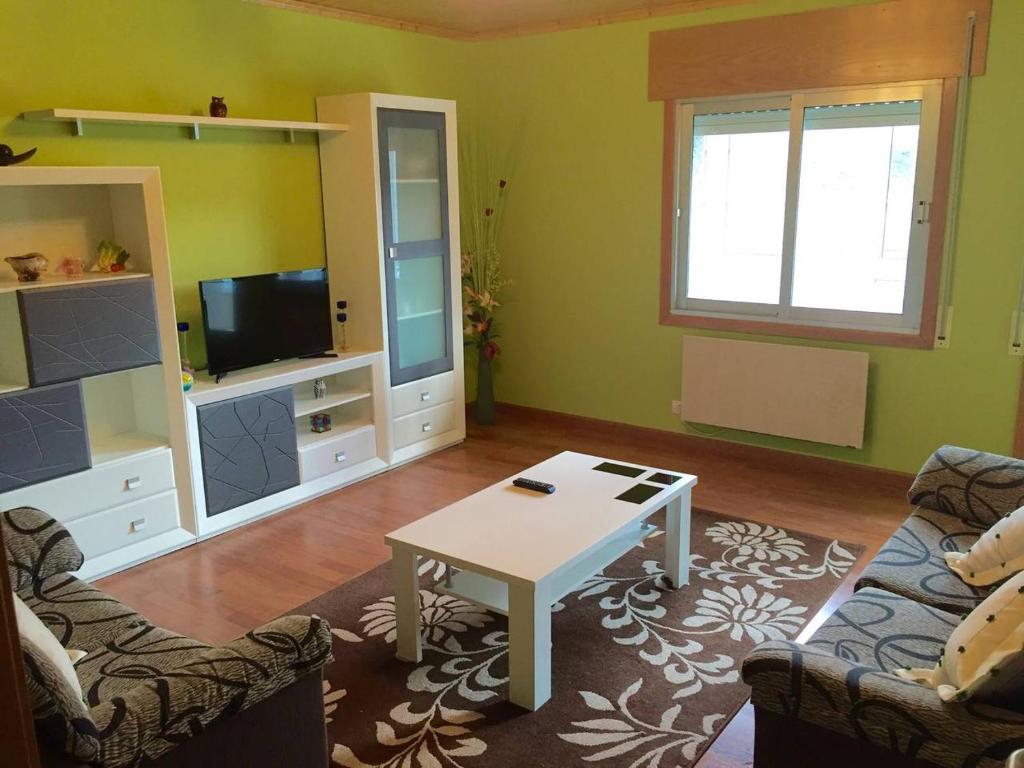 a living room with a couch and a table at Apart. cerca de Playa Catedrales in Lourenzá