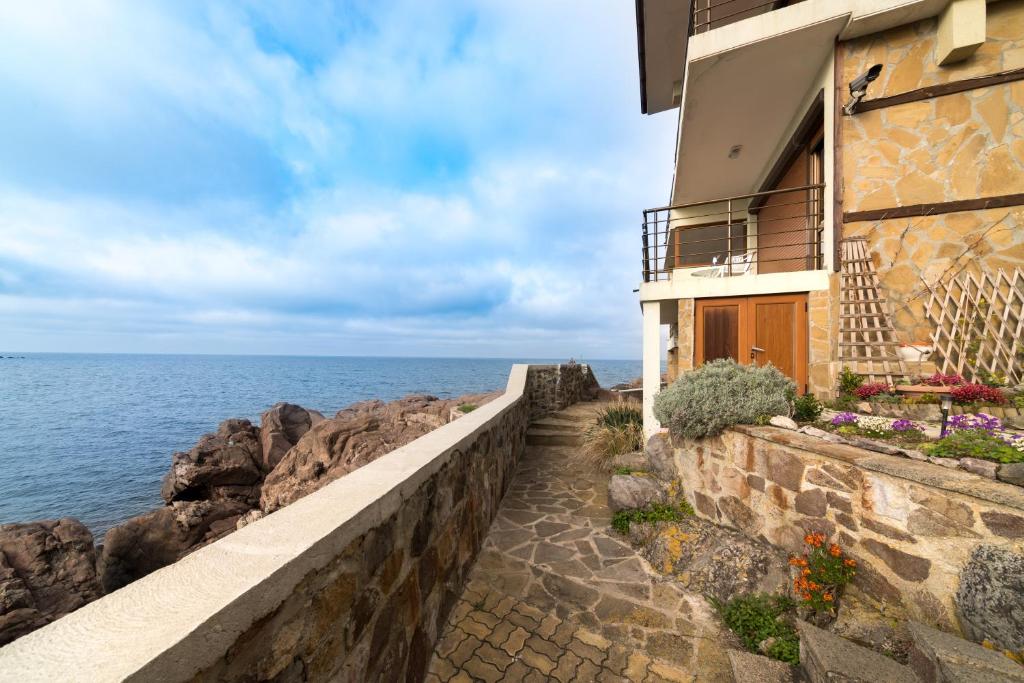 a building on the side of the ocean at Sozopol Seaside Apartment in Sozopol