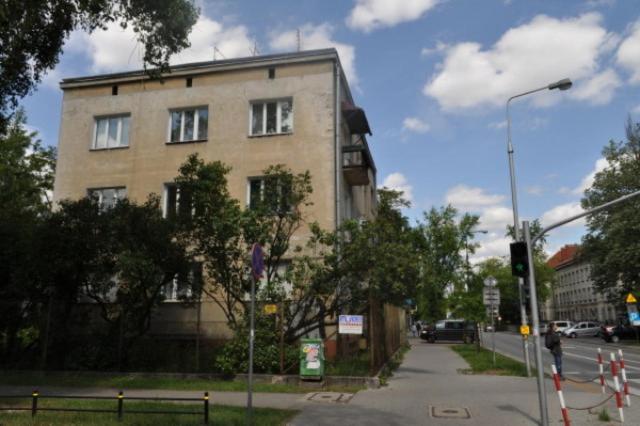 a building on the side of a street with a traffic light at Student-House Kazimierzowska in Warsaw