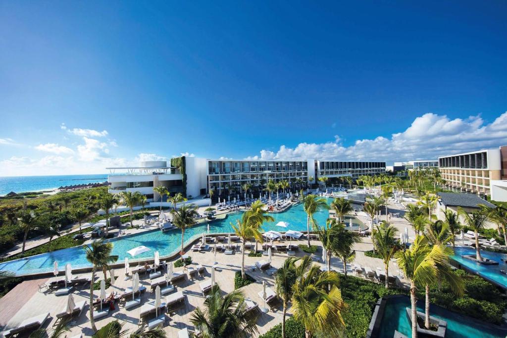 an aerial view of a resort with a pool and the ocean at TRS Coral Hotel - Adults Only - All Inclusive in Cancún