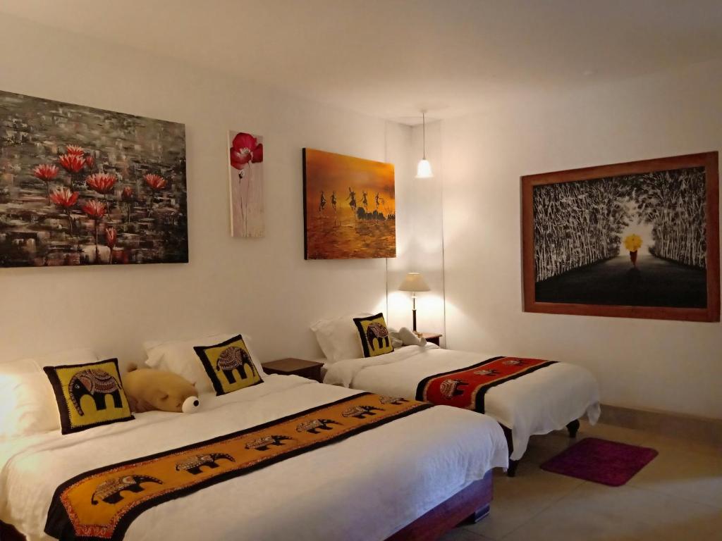 Postel nebo postele na pokoji v ubytování Kaya Residence Kandy