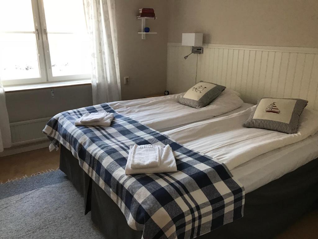 a bedroom with two beds with towels on them at Stiftsgården i Rättvik in Rättvik