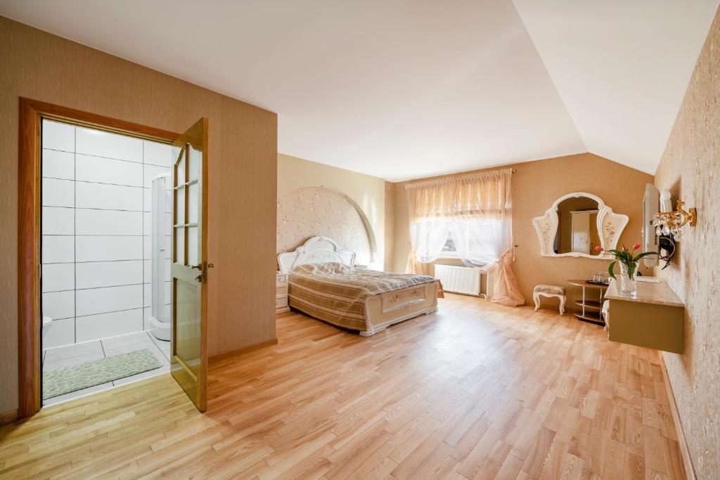 um quarto com uma cama e uma cabina de duche ao nível do chão em Adelės Vila em Palanga
