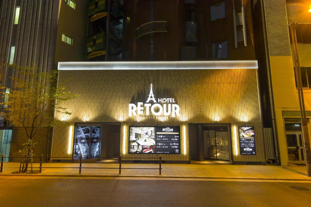a store front of a new return at night at ルトゥール難波 RetourNANBA 男塾ホテルグループ in Osaka