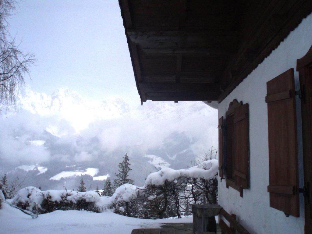 a view of a snow covered mountain from a house at Ferienhaus Soregina in Ellmau