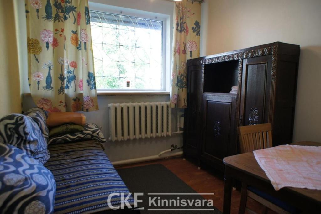 a living room with a couch and a window at Private Apartment in Tallin (Pelguranna) in Tallinn