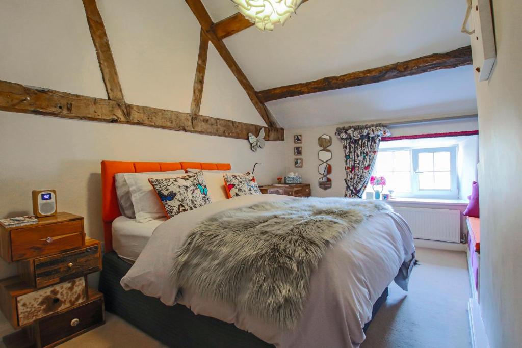a bedroom with a large bed and a window at Oh So Snug in Whalley