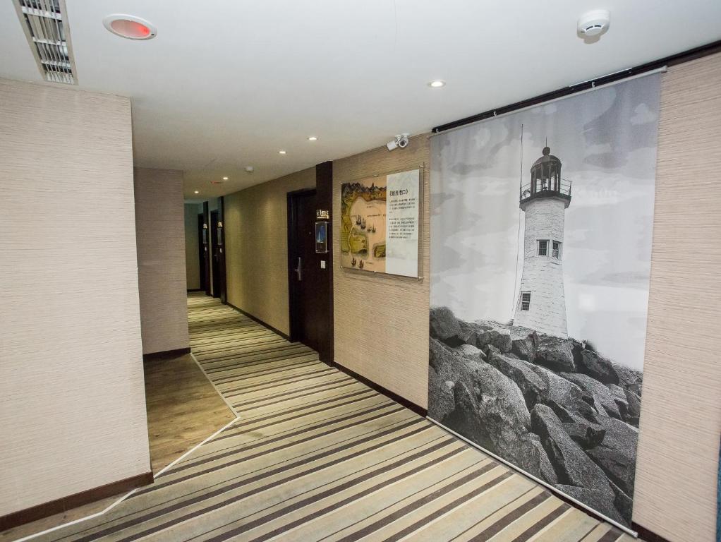a hallway with a wall mural of a lighthouse at Khan Hotel in Kaohsiung