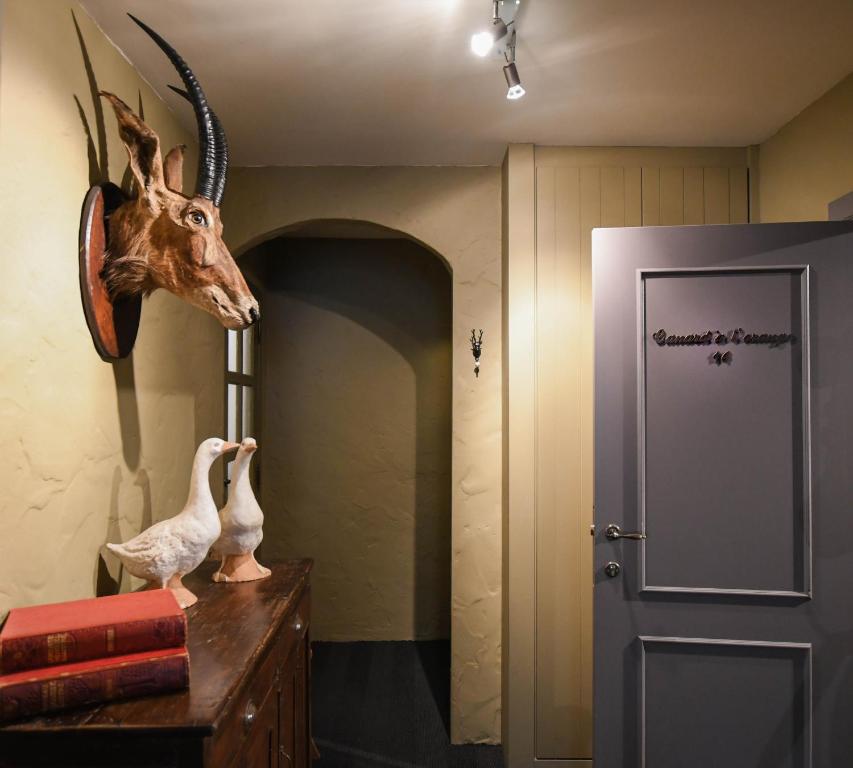 a antelope head on a dresser next to a door at Residentie De Laurier in Knokke-Heist