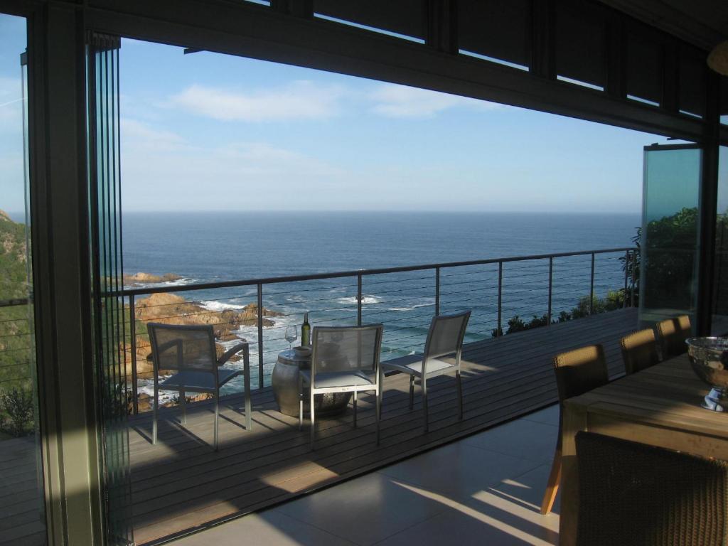 a balcony with a view of the ocean at Blue Horizon in Knysna