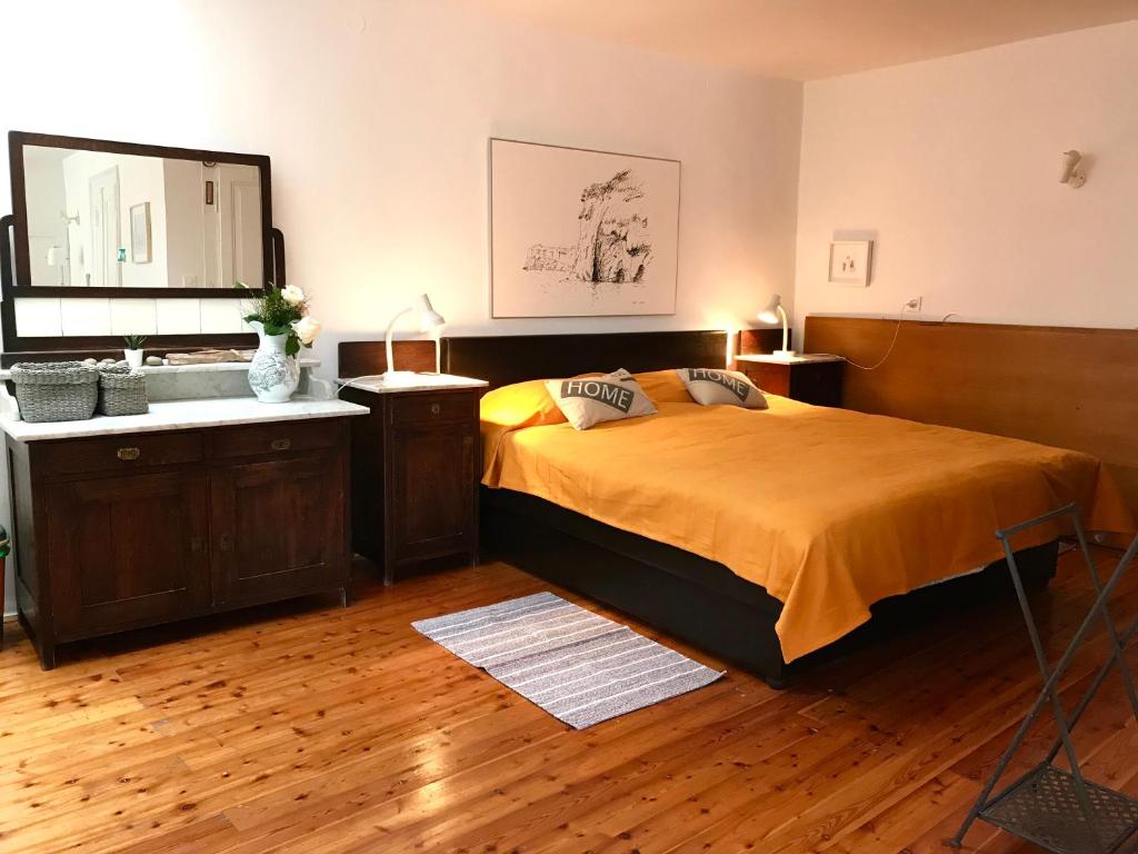 a bedroom with a large bed and a sink at Studio Doklestic in Dubrovnik