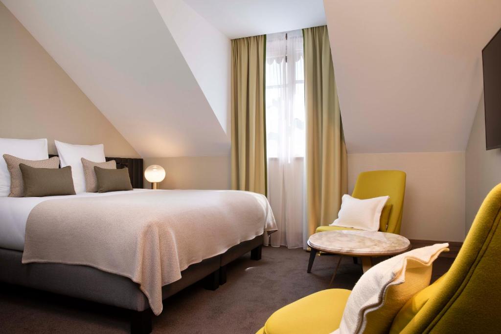 Postel nebo postele na pokoji v ubytování Hotel D Geneva