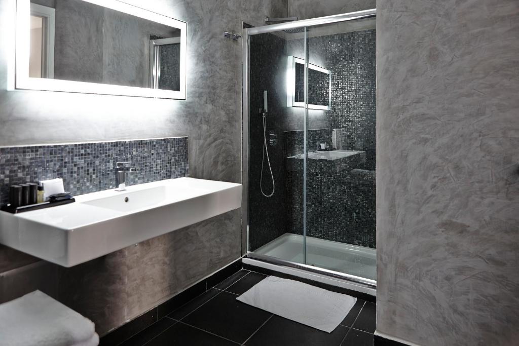a bathroom with a sink and a shower at La Suite Boutique Hotel in Procida