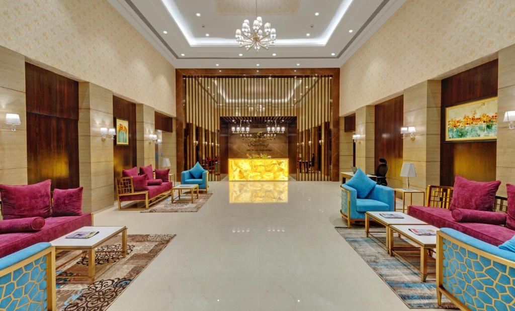 a lobby with purple and blue furniture and a fire place at The Fern Residency, Satara Maharashtra in Satara