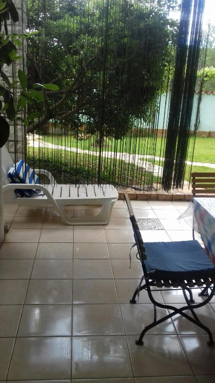 a chair sitting in a room with a tub at Villa Verde Apartments and Rooms in Premantura