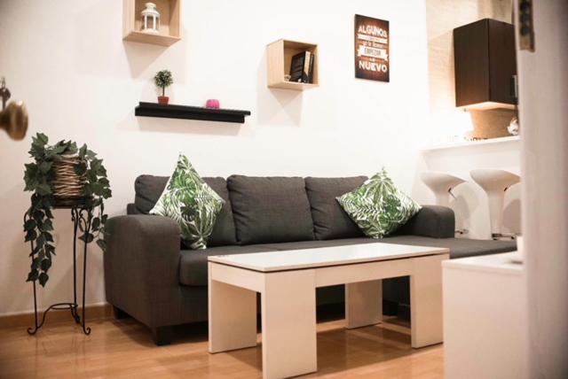 a living room with a couch and a table at NICE HOME city center in Melilla