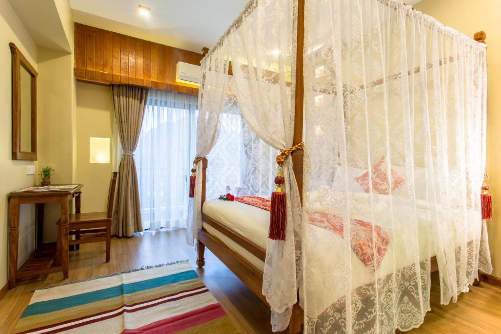 Postel nebo postele na pokoji v ubytování Hotel Mala Pokhara