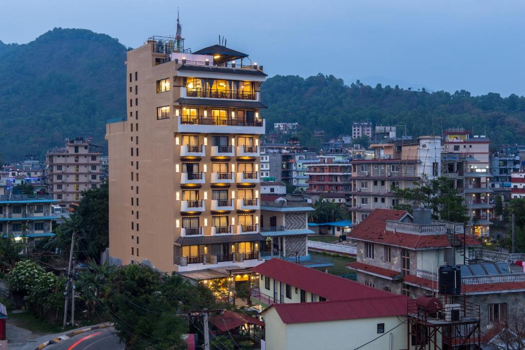 a tall building in the middle of a city at Hotel Mala Pokhara in Pokhara