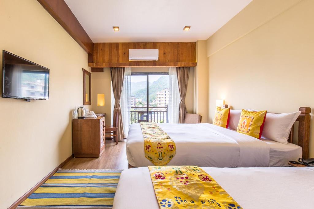 Postel nebo postele na pokoji v ubytování Hotel Mala Pokhara