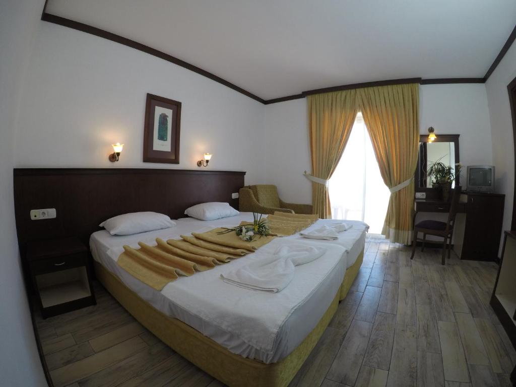 - une chambre avec un grand lit et une grande fenêtre dans l'établissement Nar Hotel, à Kemer