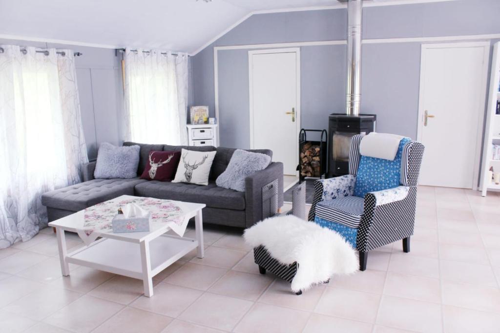 a living room with a couch and a table and chairs at Schwedenhaus Lillkvist in Uddeholm