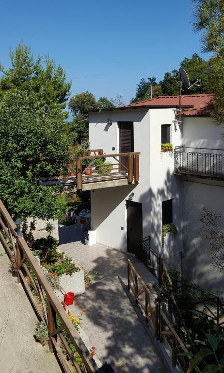 a white house with a wooden fence next to it at Casa Vacanze Fontanelle in Badolato