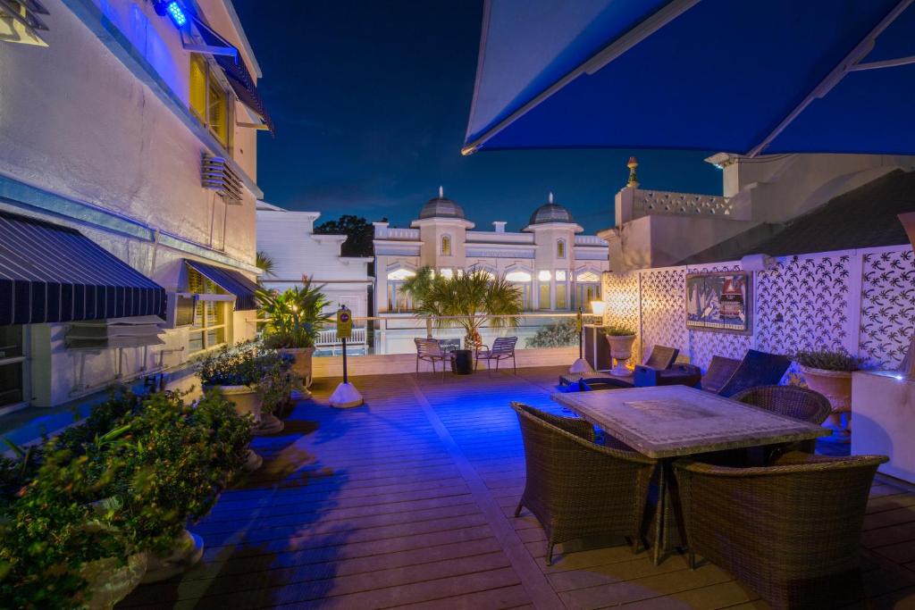 a patio with a table and chairs and a building at Pegasus International Hotel in Key West