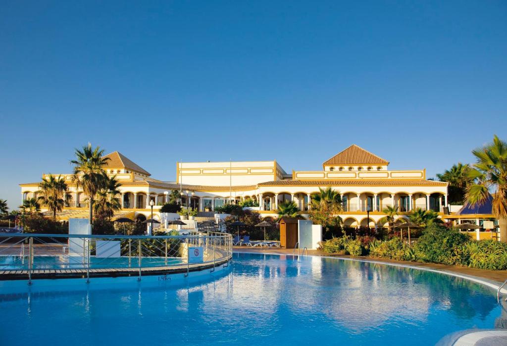uma grande piscina em frente a um resort em Aldiana Club Andalusien em Chiclana de la Frontera