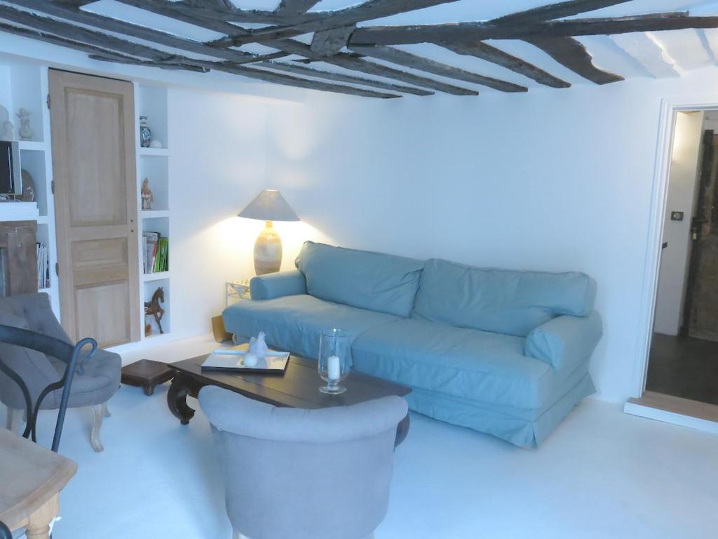 a living room with a blue couch and a table at Apartment Saintonge CityCosy in Paris