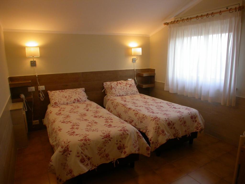 Postel nebo postele na pokoji v ubytování Hotel Il Roscio