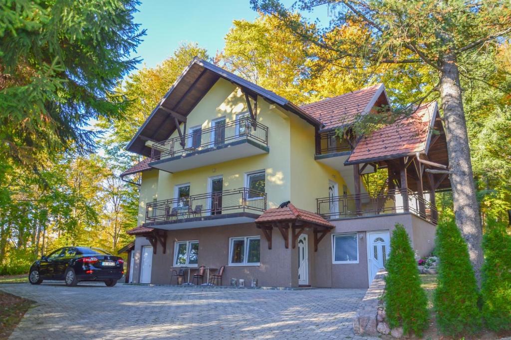 a house with a car parked in front of it at Vila Savinka in Zlatibor