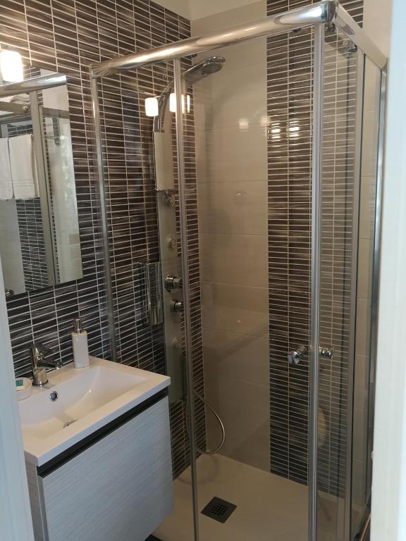 a bathroom with a glass shower and a sink at B&B Il Mare degli Dei in Letojanni