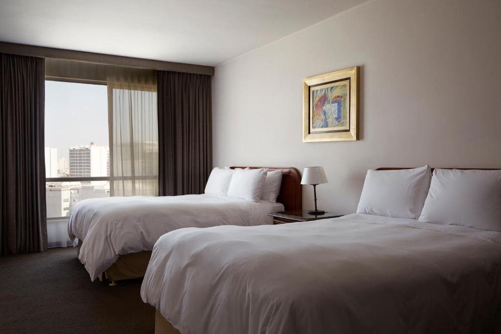 Letto o letti in una camera di BTH Hotel Lima Golf