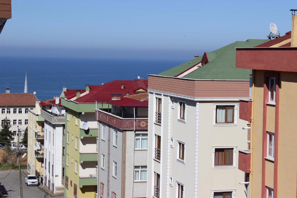 a group of buildings with the ocean in the background at Trabzon Airport Apartment in Trabzon