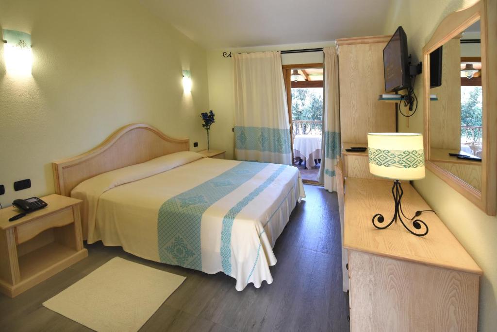 Postel nebo postele na pokoji v ubytování Hotel Su Giganti