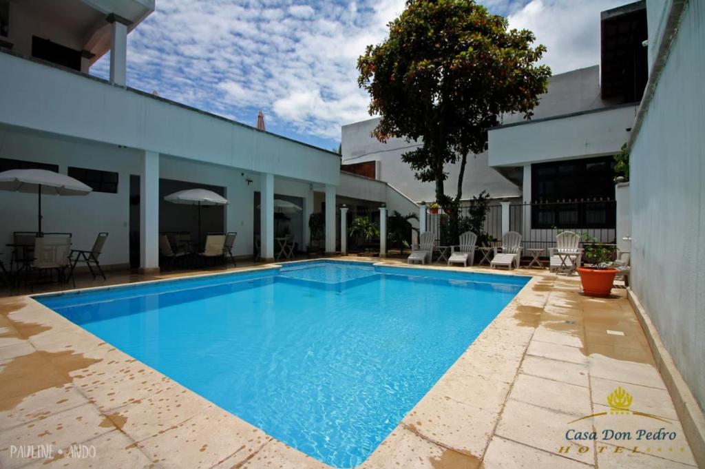 a large blue swimming pool next to a building at Hotel Casa don Pedro in San Pedro La Laguna