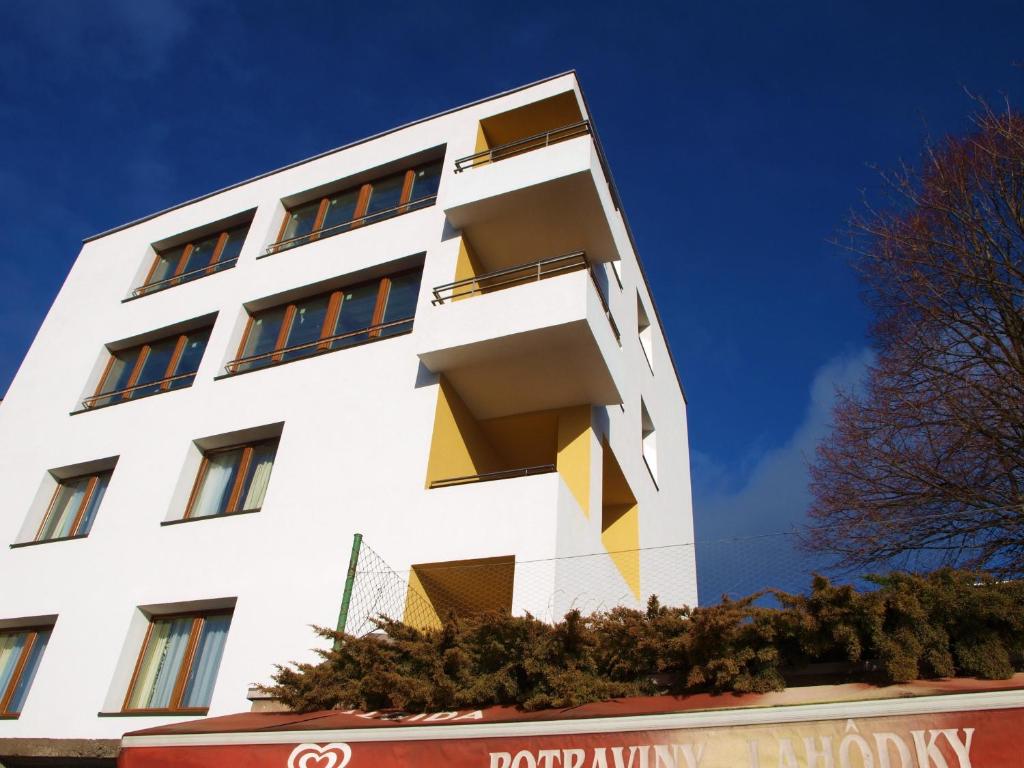 a white building with windows on the side of it at Apartments Lafranconi in Bratislava