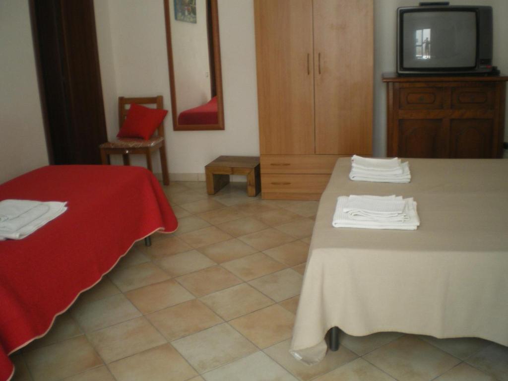 カンポベッロ・ディ・マツァーラにあるDa Matìのベッド2台とテレビが備わるホテルルームです。