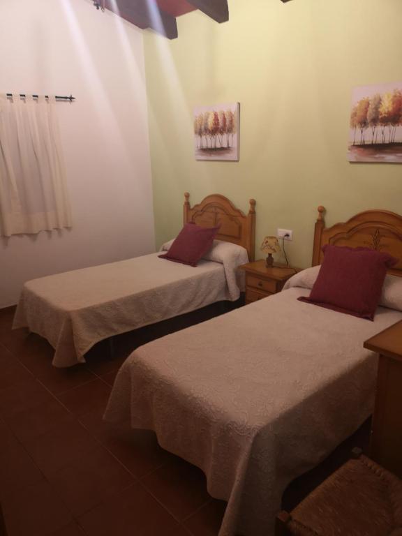 A bed or beds in a room at CASA RURAL LA DEHESILLA