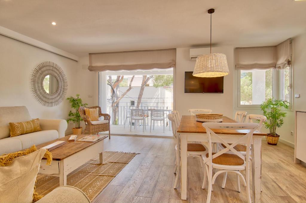 a living room with a table and a couch at Llafranc Centre, Totally Refurbished in Llafranc