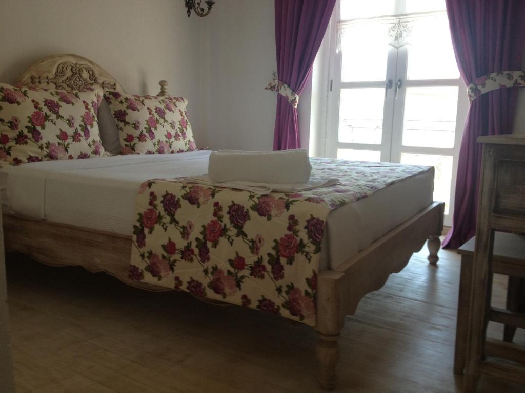 a bedroom with a bed with a laptop on it at Ciftekuyu Hotel in Alaçatı