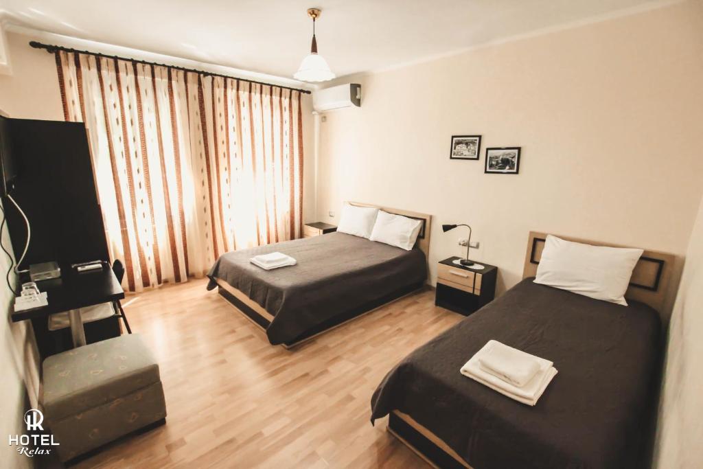 Postel nebo postele na pokoji v ubytování Hotel Relax