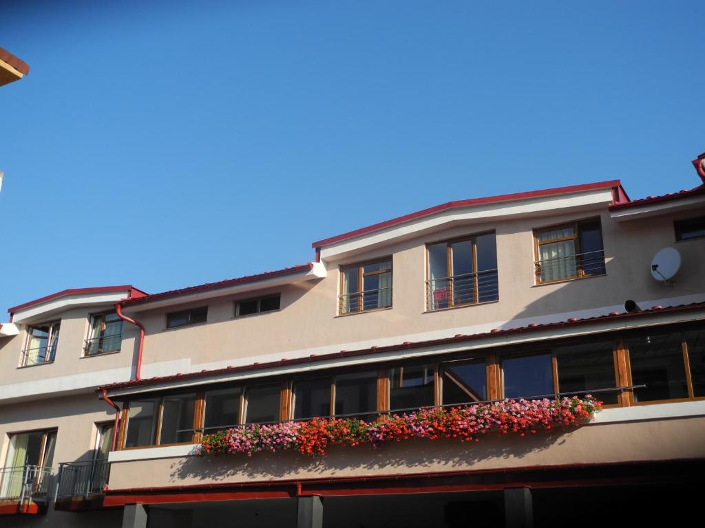a building with flower boxes on the side of it at A 7 - Avenue 7 Penzion in Prešov
