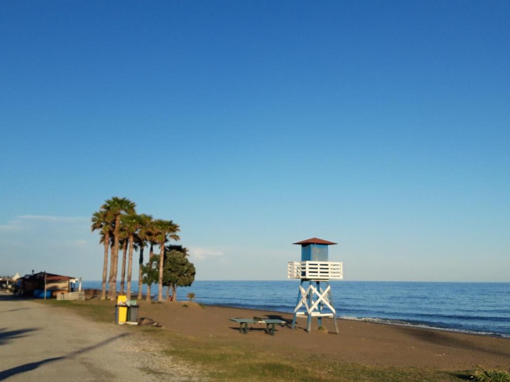 a lifeguard tower on the beach near the ocean at Yerbabuena Añoreta Golf and Beach House in Rincón de la Victoria