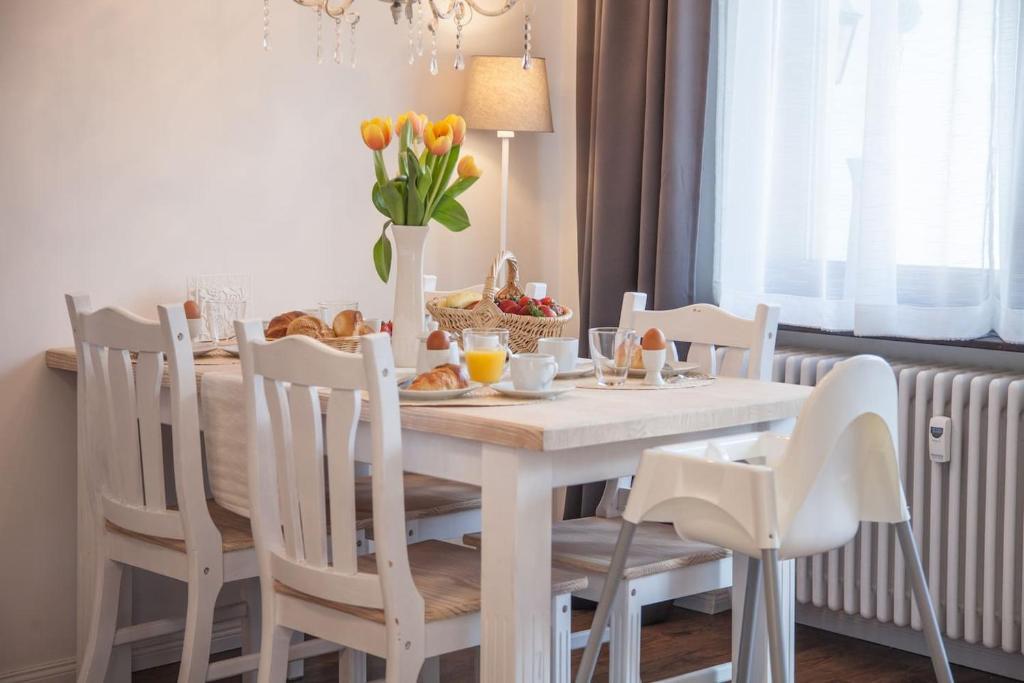 a dining room table with a white table and chairs at Apartment JoniFee am Titisee in Titisee-Neustadt