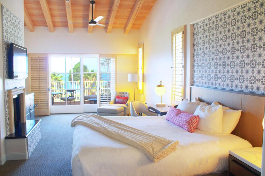 a hotel room with a bed and a living room at La Valencia Hotel in San Diego